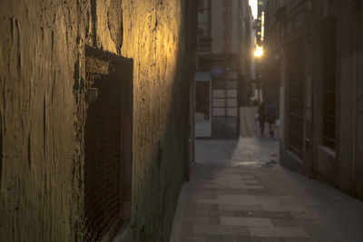 Street amidst buildings in city at night