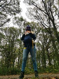 Low angle view of man standing in forest