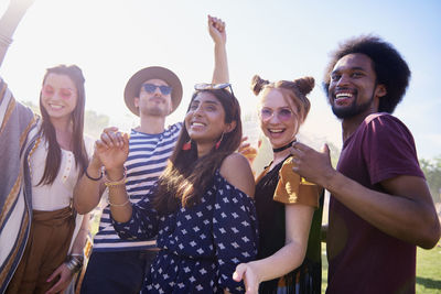 Group of happy friends partying during sunny day