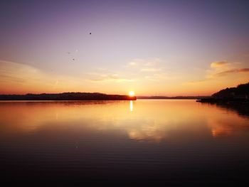 Scenic view of lake against sky during sunset