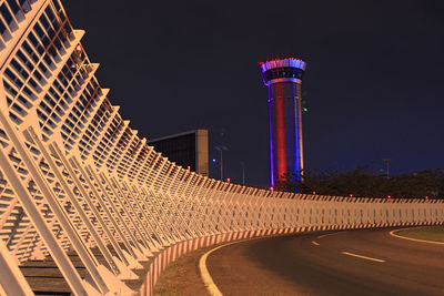 Illuminated building against sky at night