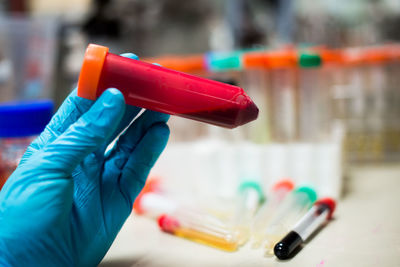 Cropped hand examining in laboratory