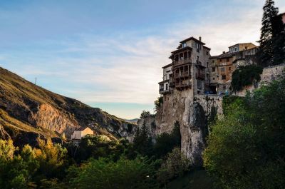 Castle by mountain against sky