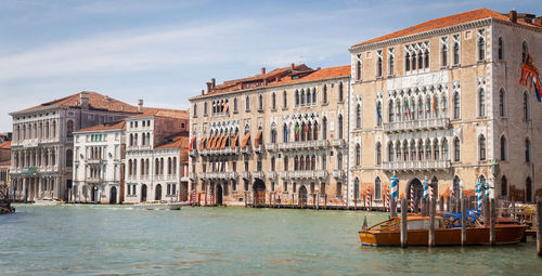 Grand canal by buildings against sky