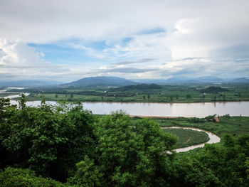 Scenic view of lake against cloudy sky