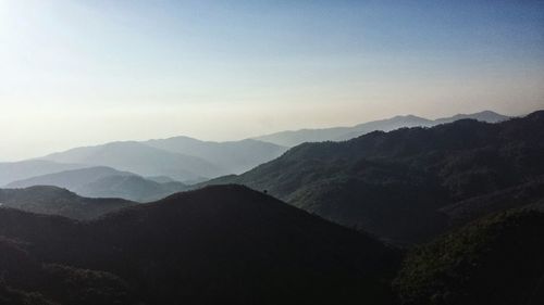 Scenic view of mountains against cloudy sky