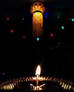 Low angle view of illuminated candles