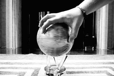 Close-up of hand holding glass ball