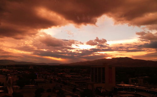 Dramatic sky over city at sunset