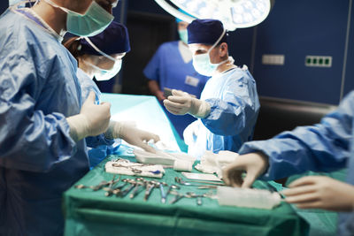 Doctors operating patient in emergency room