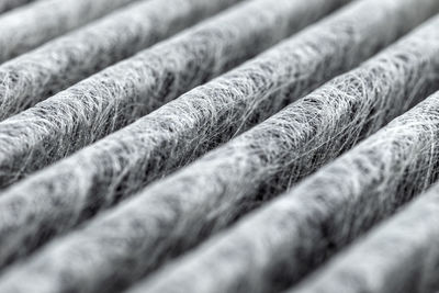 A macro shot of the surface rectangular, carbon cabin filter.  fibers arranged in diagonal lines.