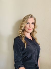 Portrait of a smiling young woman against wall