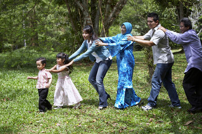 Happy multi-generation family playing in park