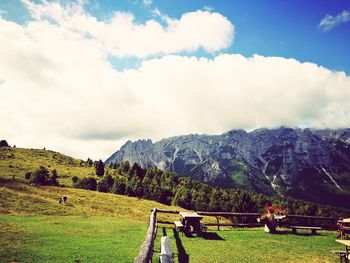 Scenic view of field and mountains against sky