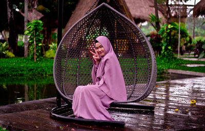 Woman sitting on pink water