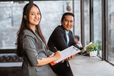 Portrait of young businesswoman using digital tablet