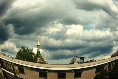 Low angle view of buildings against cloudy sky