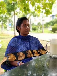 Woman sitting on table outdoors