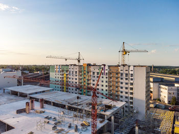 High angle view of construction site by buildings against sky