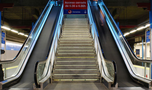 Sign board over escalator at subway station