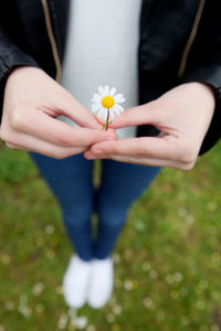 Woman holding white flower