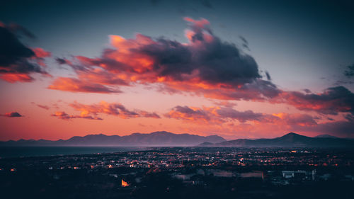 Silhouette cityscape against sky during sunset