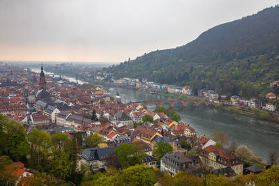 High angle view of townscape by river against sky