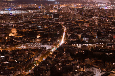 High angle view of city lit up at night