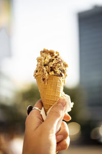 Close-up of hand holding ice cream cone