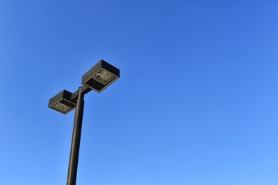 Low angle view of street light against clear blue sky