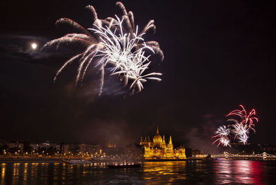 Low angle view of firework display at night