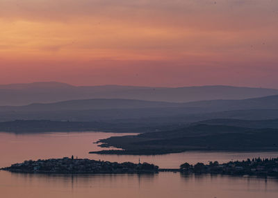 Scenic view of lake against romantic sky at sunset