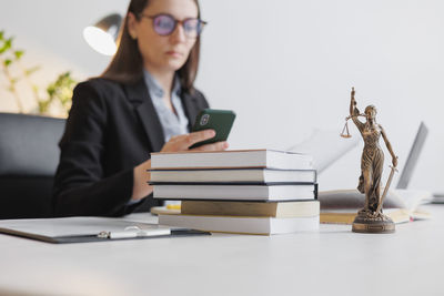 Midsection of businessman using laptop on table