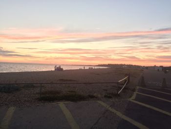 Scenic view of beach against sky during sunset