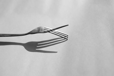 Close-up of metal on table against white background