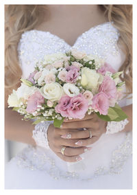 Midsection of woman holding flower bouquet
