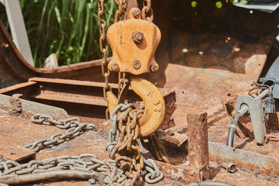 Front view reel and chain and u bolt on rusty old car interior