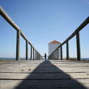 View of pier against clear blue sky