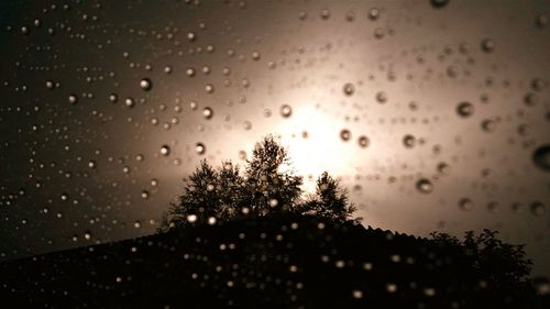 Close-up of wet glass window during rainy season