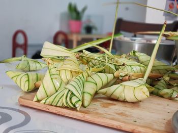 Close-up of fruits and leaves on cutting board