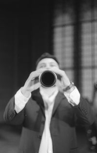 Man playing clarinet while standing at studio