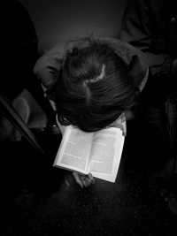 High angle view of woman reading book