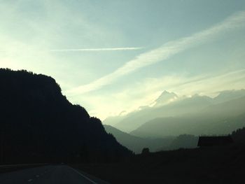 Scenic view of mountains against cloudy sky