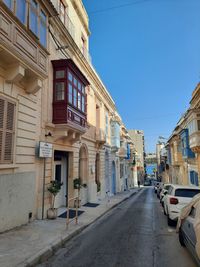 Street amidst buildings against sky