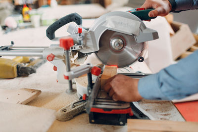 Midsection of man working at workshop