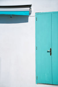 Blue door with plants on white building