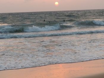 Sea waves rushing towards shore during sunset