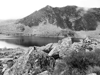 View of calm lake against mountain range