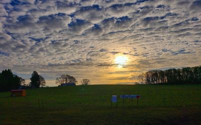 Scenic view of field against sky during sunset