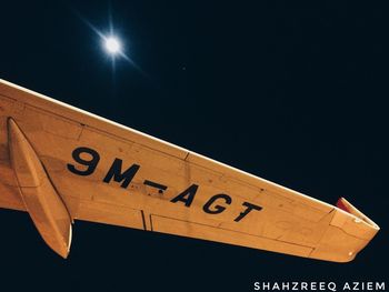 Low angle view of road sign against clear sky